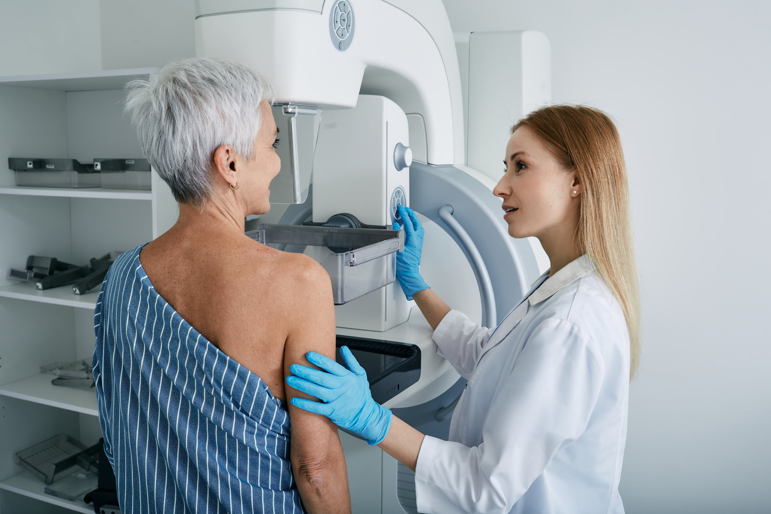 Senior woman having mammography scan at hospital with medical te